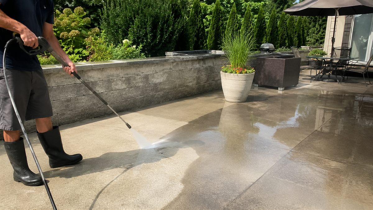 Pressure washing a shaded concrete patio in Mars, PA, near Pittsburgh